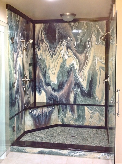 Marble shower walls with black granite trim.