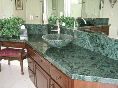Marble countertops with marble backsplashes.